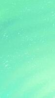 Droplets of water fall vertically against a background of minty green with white dots. Suitable for naturethemed designs and refreshing concepts. video