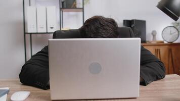 Office businessman hiding behind laptop computer making funny silly face fooling around, disrespect video