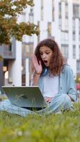 Overjoyed girl working on laptop celebrate success win money in lottery get online good new in park video