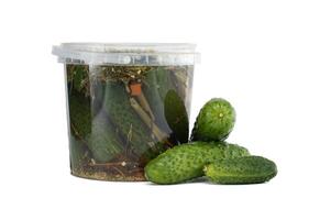 Fresh Cucumbers and Fermented Pickles in a Transparent Plastic Container photo