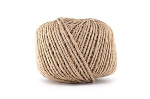 A tightly wound ball of natural twine rests against a clean white background. photo