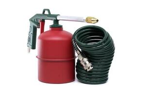 Green and Red Metal Tool with Coiled Hose on a White Background photo