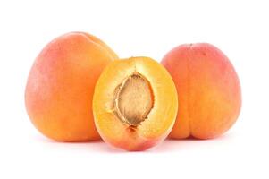 Fresh Ripe Apricots with One Cut Open Showing Stone Inside on White Background photo