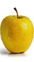 A yellow apple with water droplets on it photo