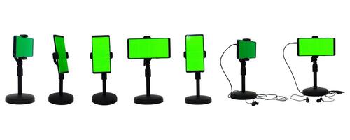collection of smartphones with green screen in holder on white background photo
