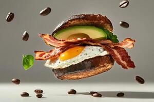 A bacon egg and cheese sandwich with avocado photo