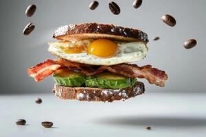 A sandwich with bacon, avocado and an egg photo
