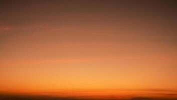 Calming orange sunset glows above peaceful horizon in summer. Peaceful sky at dusk create serene atmosphere for relaxation meditation background nature landscape scenic view summer evening tranquility photo