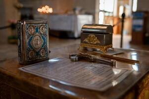 A small table with a silver box and a pen photo