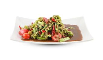 Close-Up of Spicy Long Bean Salad with Fresh Vegetables in a Ceramic Bowl isolated on white background with clipping path. Thai street food. photo