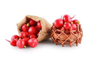 Fresh radish with red skin in a sack and basket isolated on the white background, clipping path. photo