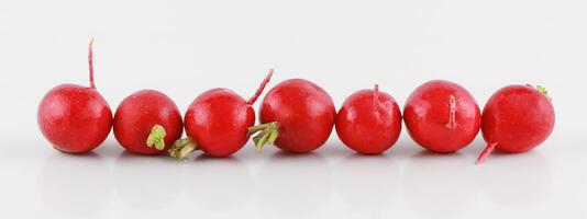 Fresh set of radish with red skin in a sack and basket isolated on the white background, clipping path. photo