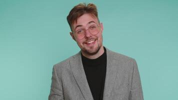 Man pointing to camera and looking with playful happy expression, making choice, showing direction video