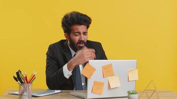 Inefficient tired lazy business man working sleeping on laptop computer with eyes stickers on face video