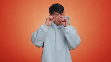 Man showing a little bit gesture with sceptic smile, showing minimum sign, measuring small size video