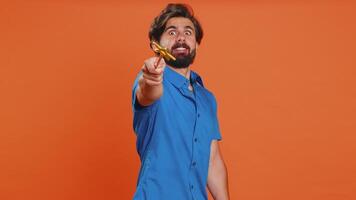 Magician witch young man gesturing with magic wand making wish come true, casting magician spell video