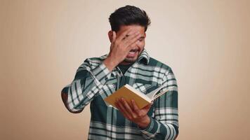 Happy hindu man reading funny interesting fairytale story book, leisure hobby, education, learning video
