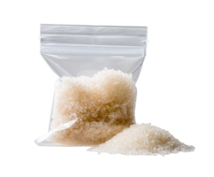 White sugar in a sealed bag with loose granules on the table png