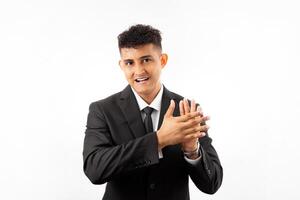Portrait of a man wearing business suite clapping and applauding happy and joyful, smiling proud hands together. photo