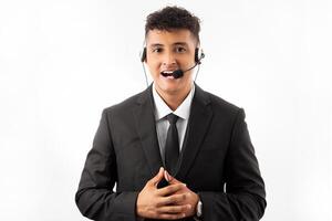 Young handsome call center agent man with beard working using headset over blue background happy face smiling with crossed arms looking at the camera. Positive person. photo