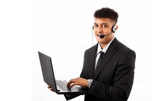 Hispanic call center agent man using computer laptop smiling with a happy and cool smile on face. showing teeth. photo