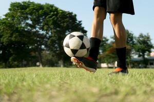 Soccer player juggling ball, showing his skill and dedication on the field photo