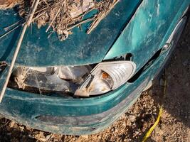 close-up damaged, flood-affected car enveloped in layers of mud and debris. Great for topics on disaster aftermath and city resilience photo