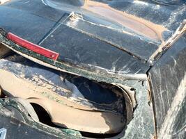 Detailed image of destroyed vehicle, covered with thick mud following natural catastrophe. Can be used for articles about climate change and flood risks photo
