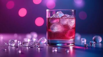 A vibrant, illuminated scene featuring a cocktail glass adorned with ice cubes against a blurred, bokeh background. photo