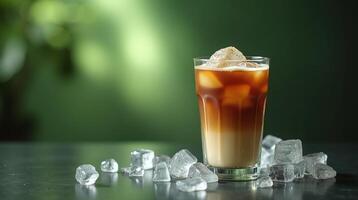 A refreshing beverage with ice cubes on a table. photo