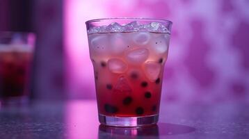 A glass filled with ice and a red beverage, creating a captivating visual. photo