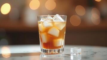 Iced beverage served in a clear glass, set against a blurred backdrop with bokeh lights. photo
