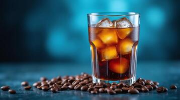A glass filled with refreshing iced coffee with ice cubes on a blue background. photo