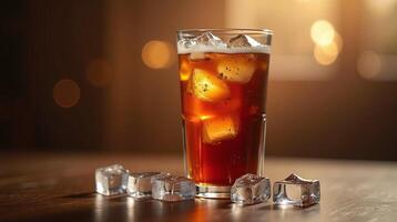 Garnished with ice cubes, a glass holds a refreshing beverage against a softly illuminated background. photo
