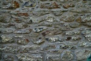 stone wall patterned texture or background. Gey stone texture background, close-up panoramic image photo
