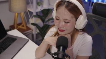 High angle of podcast host leaning in while speaking during live show video