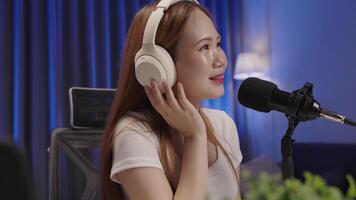 Side view of podcast host speaking into microphone during live session. video