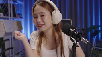 Podcast host responding to viewer comments during live stream, medium close up. video