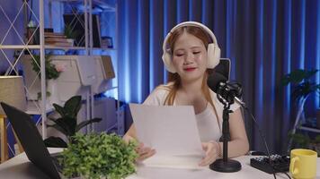 Medium shot of a podcast host reading and responding to viewer comments. video