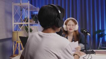 Podcast host interviewing guest during live session in modern studio video