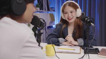 Smiling podcast host engaging with guest during conversation in home studio video