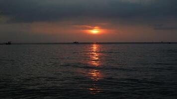 Panoramic sunset view at a luxury beach in the tropics, Serene sunset over calm ocean photo