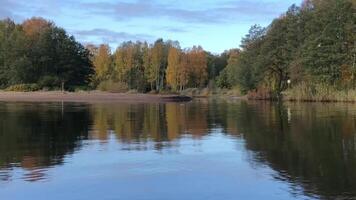 picturesque autumn landscape, colorful trees on the bank are reflected in the blue river video