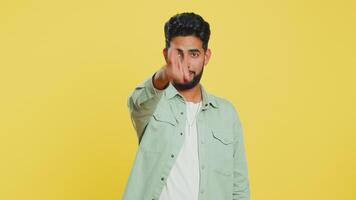 Happy Indian smiling man pointing finger to camera making winner choice showing direction select video