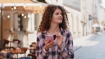 woman use smartphone typing text messages browsing internet finishing work looking at camera video