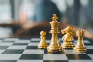 Close-up of golden chess pieces on a chessboard, highlighting strategy and competition in a modern setting. photo