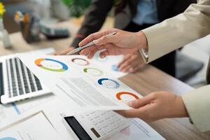 Data Analysis and Report Review. Professionals discussing visual data in a meeting. photo