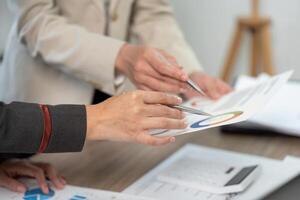 Hands of Business Professionals Reviewing Project Reports and Data Analysis. photo