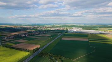 Aerial view of countryside landscape with blooming rapeseed fields and highway with moving vehicles video