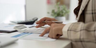 Accounting and Financial Analysis. Professional calculating expenses with a calculator. photo